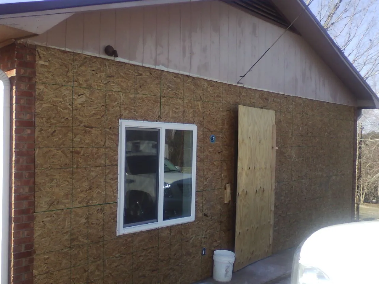OSB sheathing on a garage addition wall before siding in Elmsford
