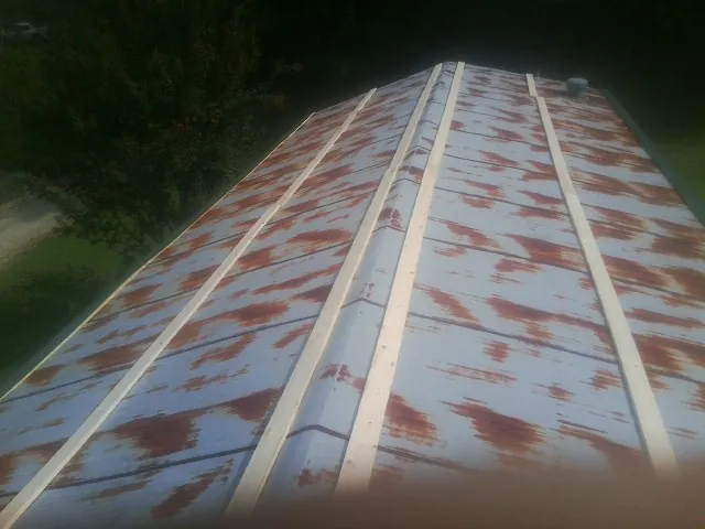 Rusted metal roof panels with new wood purlins before replacement — Storm Damage Roof Repair in Elmsford by Roofing Brothers