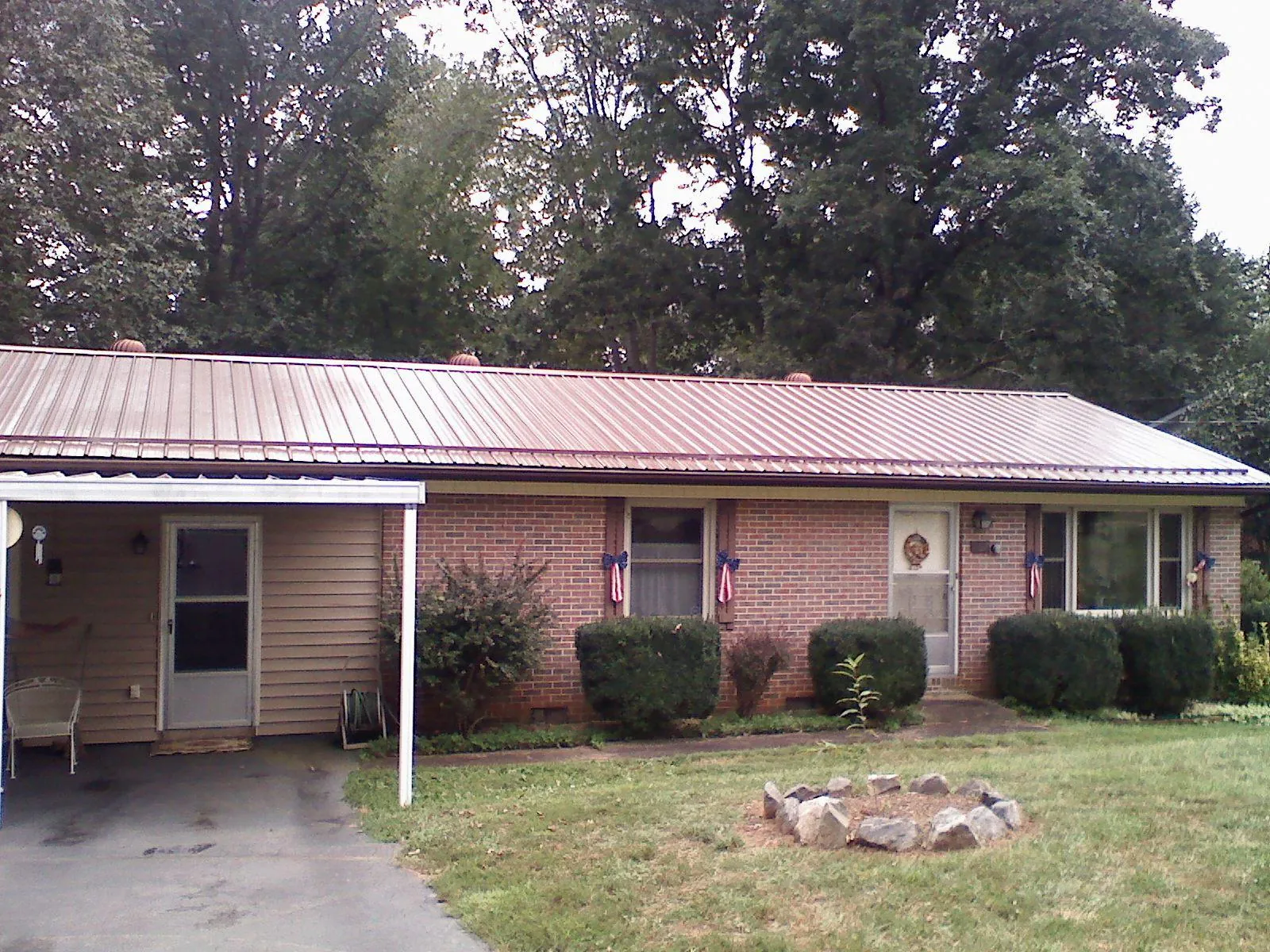 Bronze metal roof and carport on a brick ranch home — Roof Repair work by our crew in Elmsford